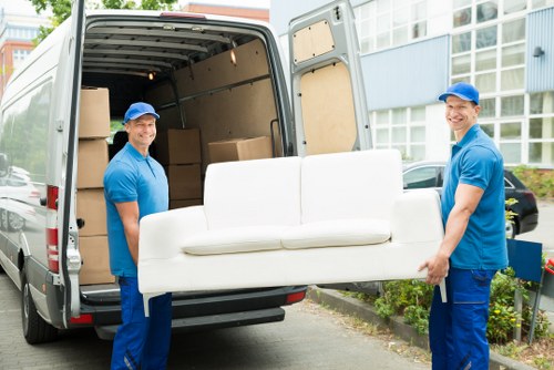 Man with van loading furniture for a Surrey home move