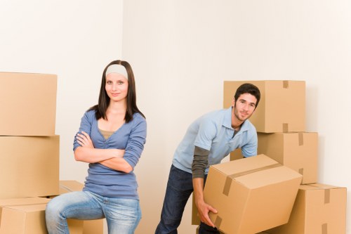 Movers handling furniture in a Surrey residential street