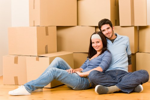 Driver and helper loading furniture into a moving van during a house move