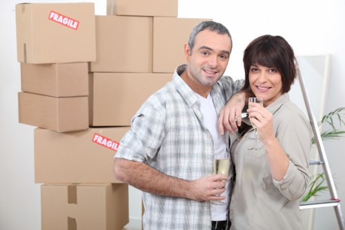 Removal team handling boxes and furniture for a Surrey home